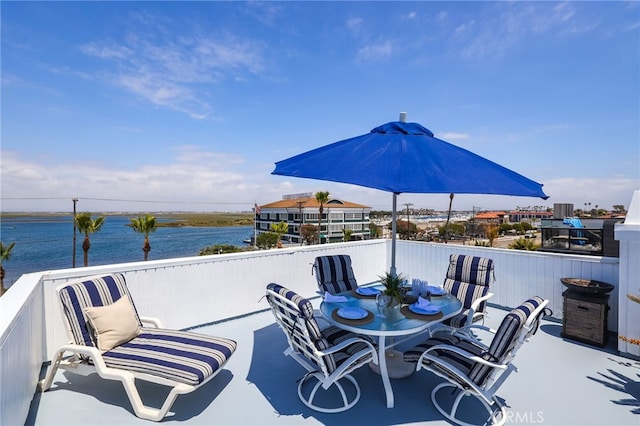 view of patio / terrace with a balcony and a water view