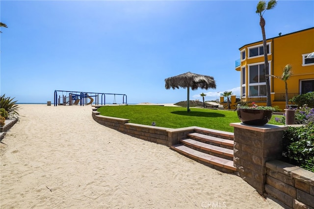 view of property's community with a yard and a water view