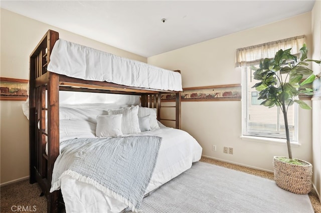 bedroom with light colored carpet and multiple windows