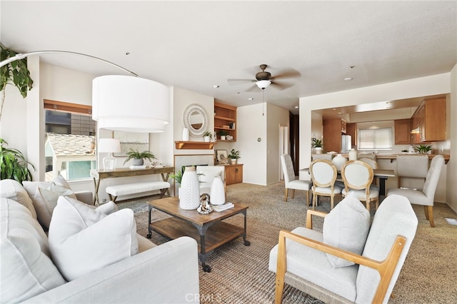 living room featuring light carpet and ceiling fan