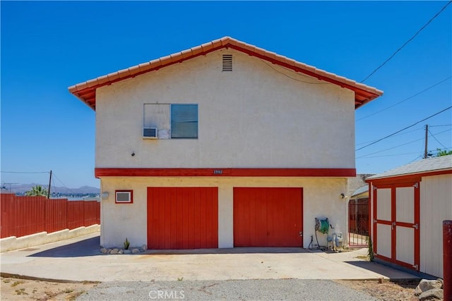 view of side of property featuring a storage shed