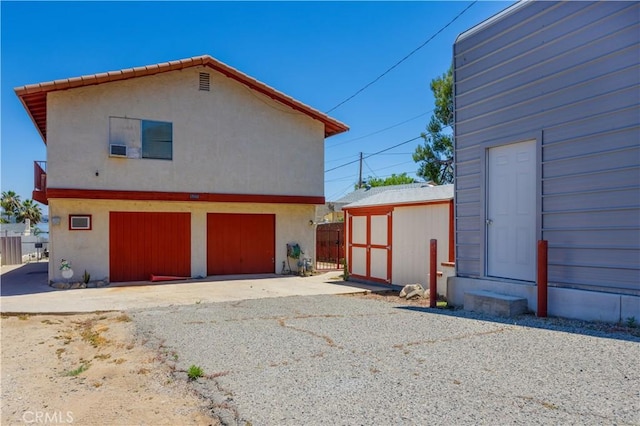 rear view of property with a storage shed