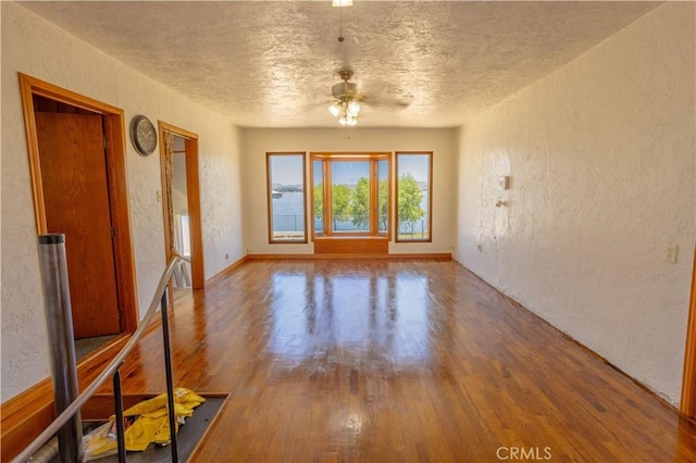 unfurnished room with ceiling fan and wood-type flooring