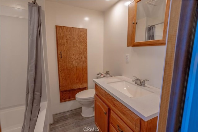 full bathroom featuring shower / tub combo, vanity, toilet, and hardwood / wood-style floors