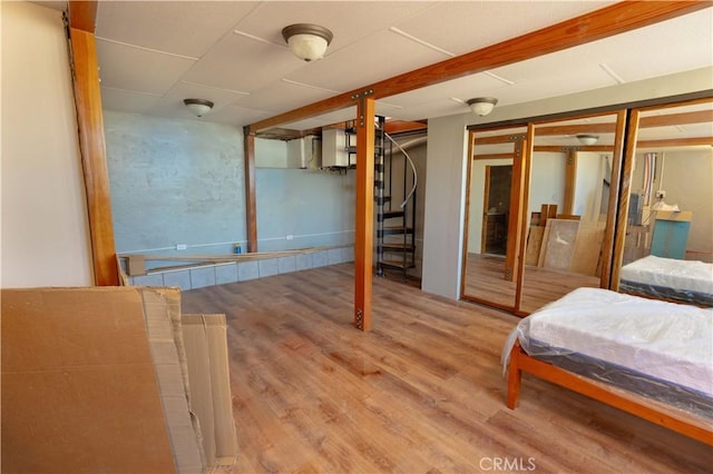 bedroom with a closet and hardwood / wood-style flooring