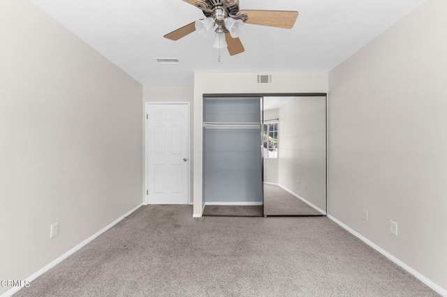 unfurnished bedroom featuring light colored carpet, a closet, and ceiling fan