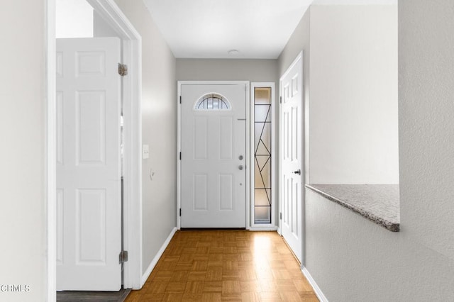 entrance foyer featuring parquet flooring