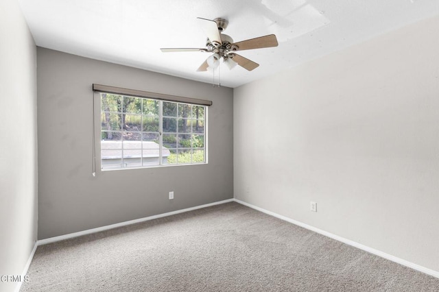 carpeted spare room with ceiling fan