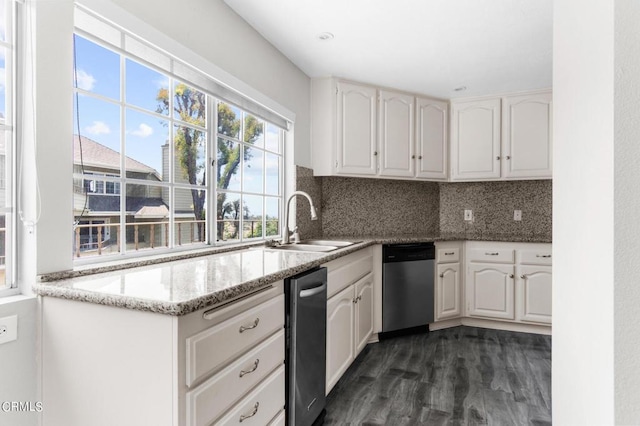 kitchen featuring backsplash, stainless steel dishwasher, sink, white cabinets, and dark hardwood / wood-style floors