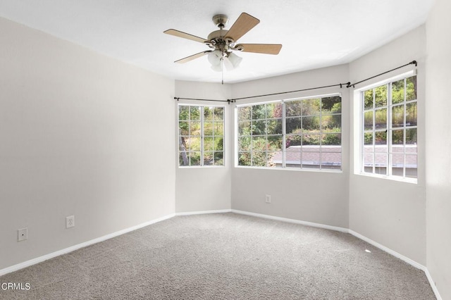 carpeted empty room with ceiling fan