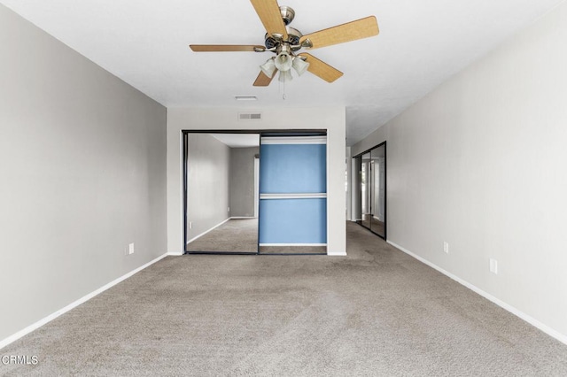 unfurnished bedroom with ceiling fan, a closet, and light colored carpet