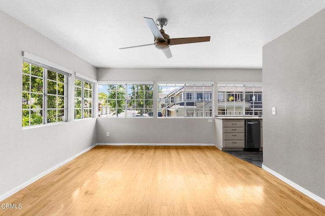 unfurnished sunroom with a wealth of natural light and ceiling fan