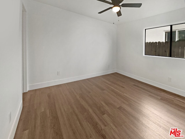 spare room with ceiling fan and hardwood / wood-style flooring