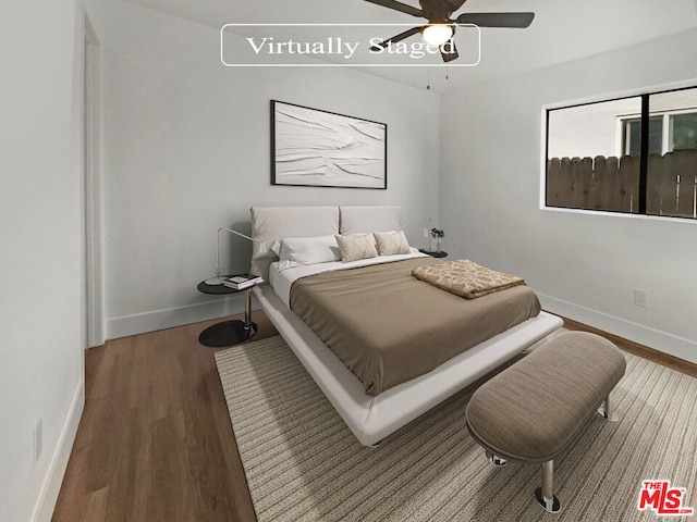 bedroom featuring ceiling fan and wood-type flooring