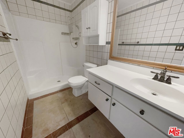 bathroom with walk in shower, tile patterned flooring, toilet, vanity, and tile walls