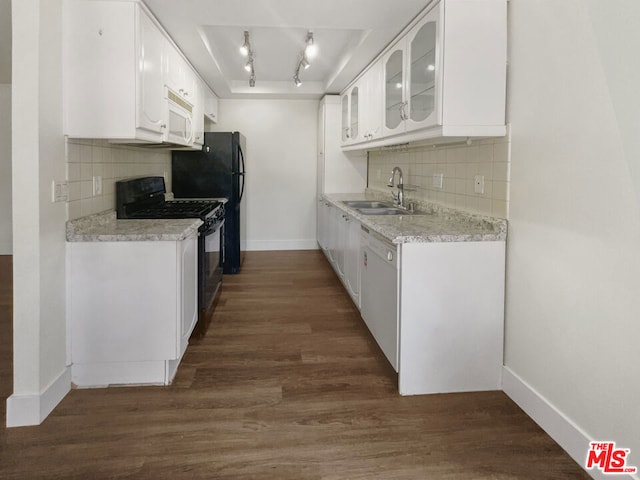 kitchen with white cabinetry, sink, dark wood-type flooring, white appliances, and decorative backsplash