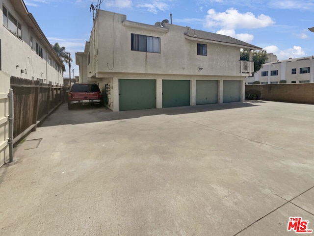 back of house featuring a garage