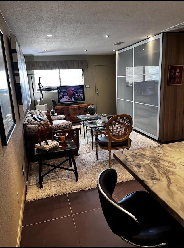 tiled living room with a textured ceiling