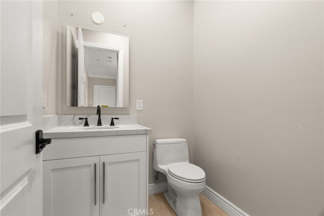 bathroom with crown molding, vanity, and toilet