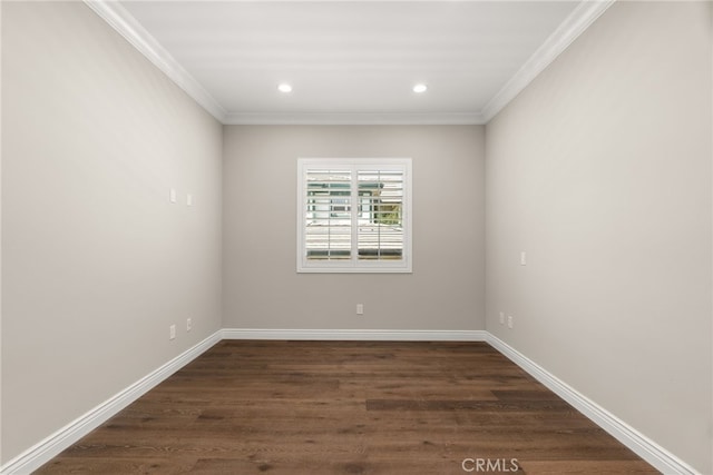 empty room featuring dark hardwood / wood-style floors and ornamental molding