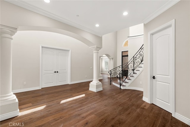 interior space featuring crown molding and dark hardwood / wood-style flooring