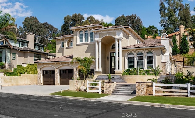 mediterranean / spanish home featuring a garage