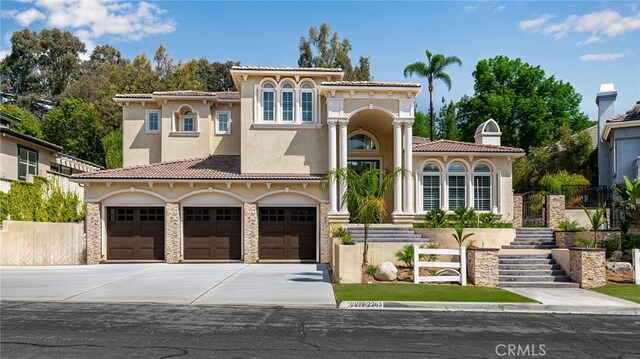 mediterranean / spanish house with a garage