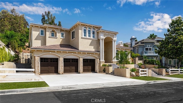 mediterranean / spanish-style house with a garage