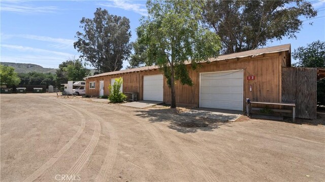 view of front of property with a mountain view, a garage, and an outdoor structure