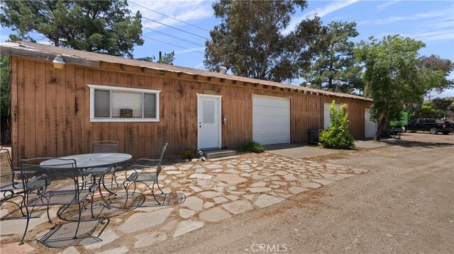 rear view of house featuring a garage