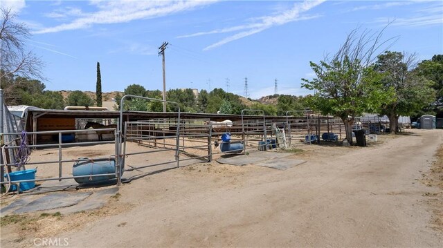 view of horse barn featuring a rural view