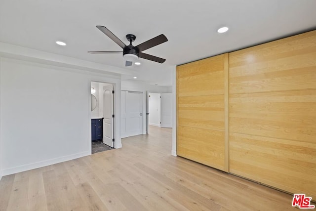 unfurnished room with ceiling fan and light hardwood / wood-style flooring