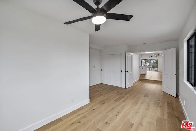 spare room with ceiling fan and light wood-type flooring