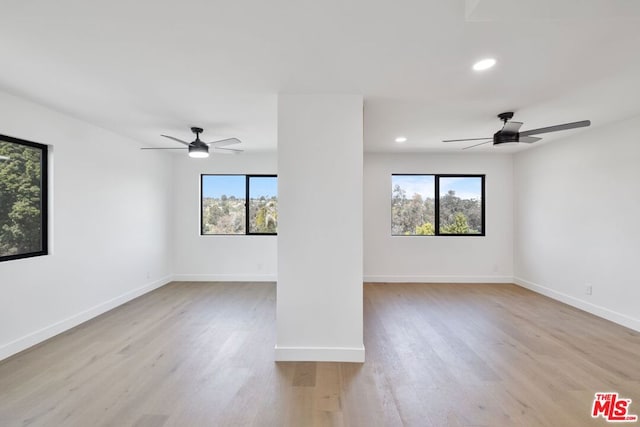 spare room featuring ceiling fan, plenty of natural light, and light hardwood / wood-style floors