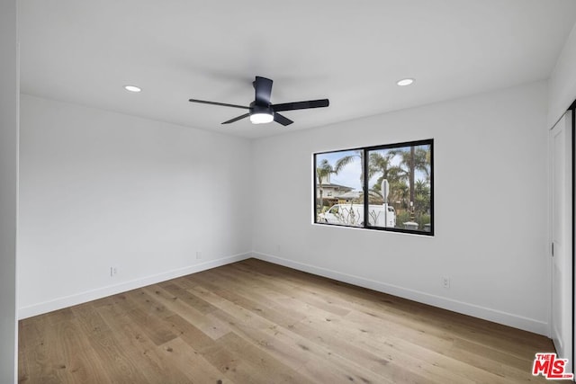 unfurnished room featuring ceiling fan and hardwood / wood-style floors