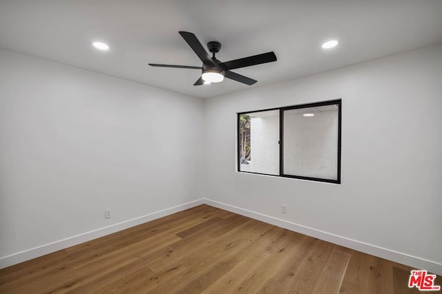 spare room with wood-type flooring and ceiling fan