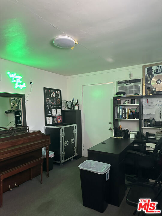 office space with a wall unit AC and concrete floors