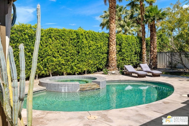 view of pool featuring an in ground hot tub