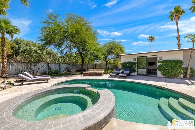 view of pool featuring an in ground hot tub, an outdoor living space, and a patio area