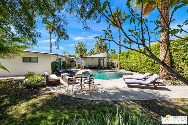 view of swimming pool featuring an in ground hot tub and a patio