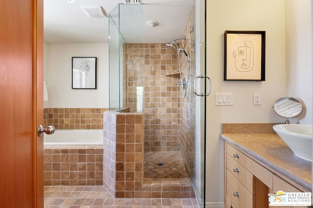 bathroom with vanity and independent shower and bath