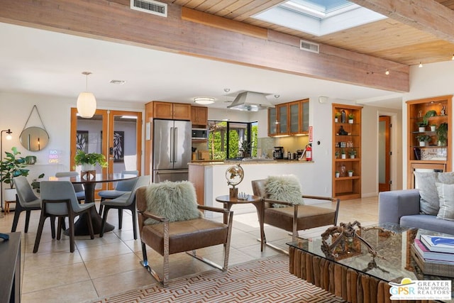 living room featuring beam ceiling, a skylight, wooden ceiling, and light tile patterned flooring