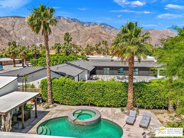 view of swimming pool with a mountain view