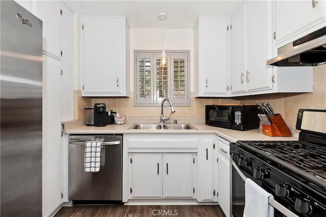 kitchen featuring pendant lighting, sink, dark hardwood / wood-style floors, appliances with stainless steel finishes, and white cabinetry