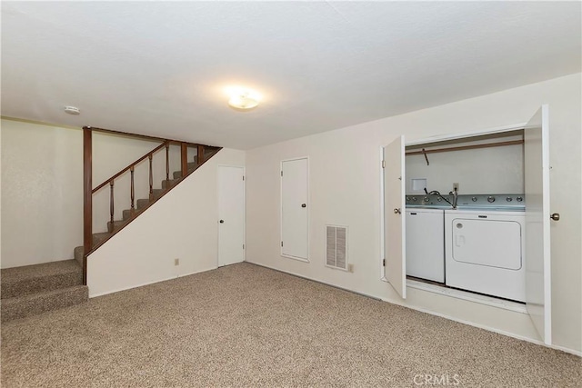 basement featuring independent washer and dryer and carpet floors