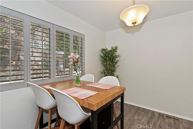 dining space featuring dark hardwood / wood-style floors