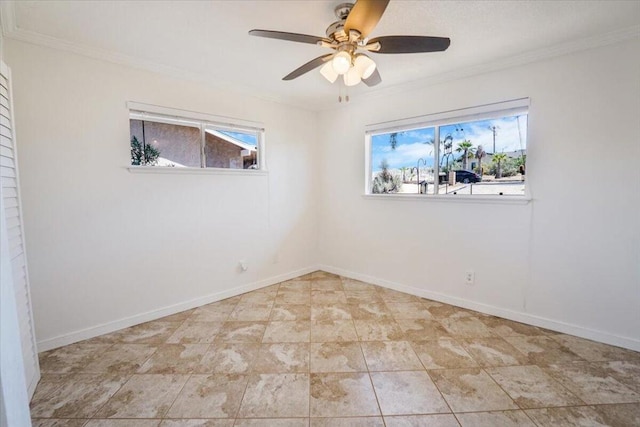 spare room featuring ceiling fan, ornamental molding, and a wealth of natural light