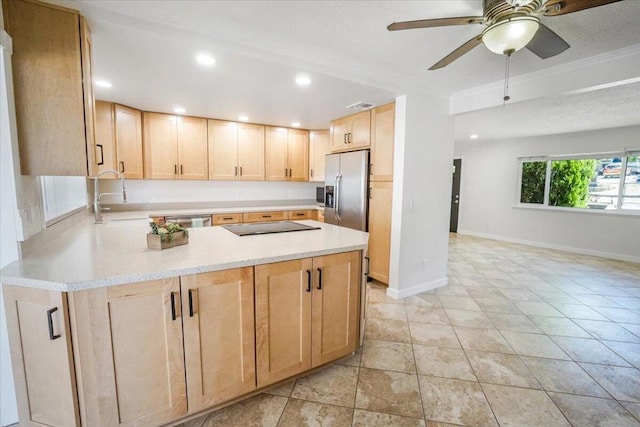 kitchen with appliances with stainless steel finishes, kitchen peninsula, light brown cabinetry, ceiling fan, and sink