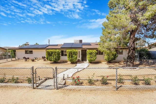 single story home featuring solar panels