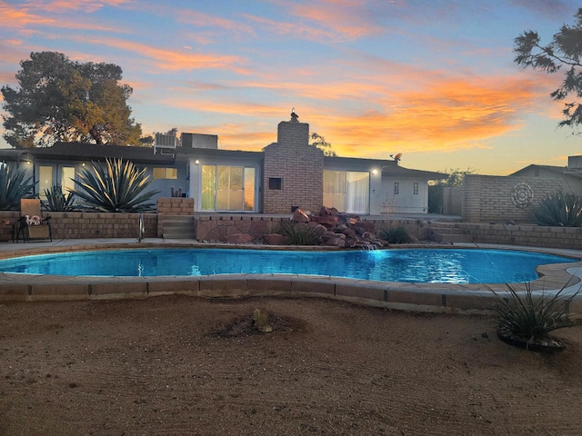 view of pool at dusk